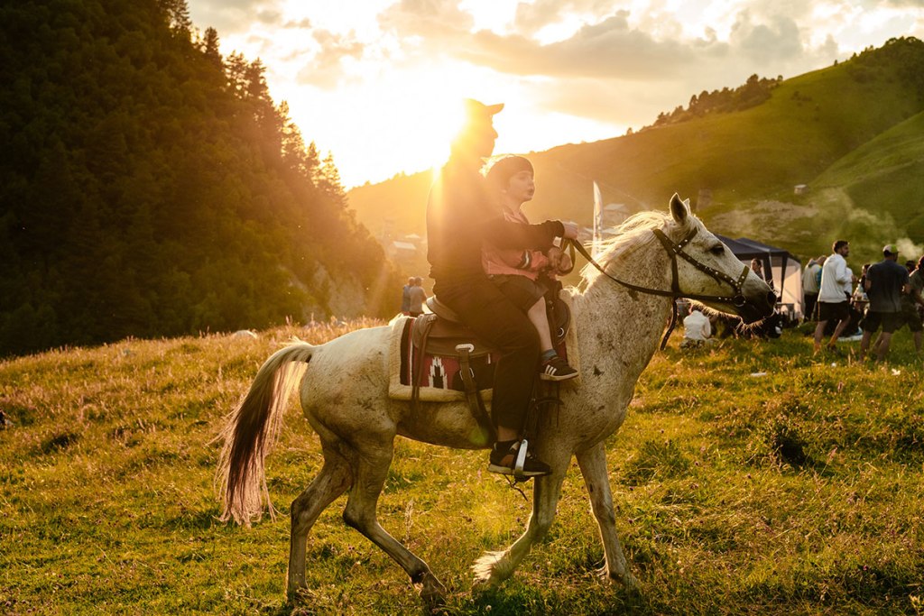 Man and boy on the horseback. Highlander Adventure, Biliki App