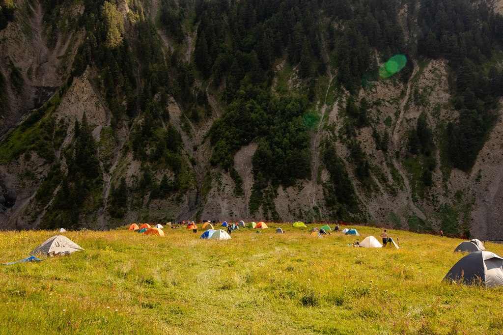 Colorful tents in camp on the field. Highlander Adventure, Biliki App
